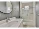 Bathroom featuring white vanity with round mirror, toilet, and shower-tub combo at 7399 Skylark Dr, Spring Hill, FL 34606