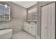 Bright bathroom featuring soaking tub, double sink vanity, tile flooring and bright natural light at 7399 Skylark Dr, Spring Hill, FL 34606