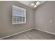 This room has gray walls, wood floors, a window for ample natural light, and overhead lighting at 7399 Skylark Dr, Spring Hill, FL 34606