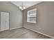 This cozy room has gray walls, wood floors, a window, a closet, and outlets on every wall at 7399 Skylark Dr, Spring Hill, FL 34606