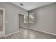 Bedroom with light gray walls, gray laminate flooring, and mirrored closet at 7399 Skylark Dr, Spring Hill, FL 34606
