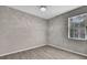 Neutral bedroom features wood floors, a ceiling fan, and a window for ample natural light at 7399 Skylark Dr, Spring Hill, FL 34606