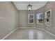This dining room features wood-look tile flooring, two windows and gray walls at 7399 Skylark Dr, Spring Hill, FL 34606