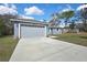 Single story house with a long drive way and two car garage at 7399 Skylark Dr, Spring Hill, FL 34606