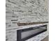 Close up view of the modern fireplace with stylish stone surround and wooden mantel at 7399 Skylark Dr, Spring Hill, FL 34606
