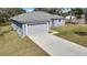 Well-maintained home with a fresh exterior, attached garage, and nicely sized front yard at 7399 Skylark Dr, Spring Hill, FL 34606