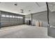Spacious garage features a large door, gray walls, overhead lighting, and plenty of storage space at 7399 Skylark Dr, Spring Hill, FL 34606