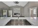 Modern kitchen view with stainless steel sink and stone countertops leading to living area at 7399 Skylark Dr, Spring Hill, FL 34606