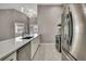 Modern kitchen with stainless appliances, stone countertops and stylish wood flooring at 7399 Skylark Dr, Spring Hill, FL 34606