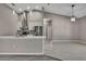Open kitchen with stainless steel appliances, gray backsplash, and an island with white countertop at 7399 Skylark Dr, Spring Hill, FL 34606