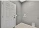 Functional laundry room with gray walls, a door, and hookups for a washer and dryer at 7399 Skylark Dr, Spring Hill, FL 34606