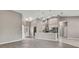 Open-concept living room with high ceilings flows into a modern kitchen with stainless steel appliances at 7399 Skylark Dr, Spring Hill, FL 34606