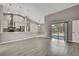 Open floor plan featuring modern kitchen and living area with sliding door to the patio at 7399 Skylark Dr, Spring Hill, FL 34606