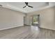 A spacious main bedroom with tray ceiling, ceiling fan, and sliding glass door to the outside at 7399 Skylark Dr, Spring Hill, FL 34606