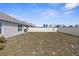 Spacious backyard featuring a partial view of white vinyl fence and sparse lawn at 7552 Gardner St, Brooksville, FL 34613