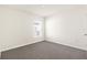 Bright bedroom features neutral walls, carpet, and a window with blinds at 7552 Gardner St, Brooksville, FL 34613