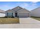 Charming single-story home with a well-manicured lawn, attached two-car garage, and neutral paint at 7552 Gardner St, Brooksville, FL 34613