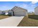 Beautiful one-story house with a lush lawn, a long driveway, and a two-car garage at 7552 Gardner St, Brooksville, FL 34613