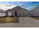 Charming single-story home with a well-manicured lawn and two-car garage at 7552 Gardner St, Brooksville, FL 34613