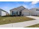 Inviting single-Gathering home featuring a well-maintained lawn and a two-car garage at 7552 Gardner St, Brooksville, FL 34613