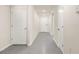 Clean, modern hallway with multiple doors, fresh paint, and tile flooring at 7552 Gardner St, Brooksville, FL 34613