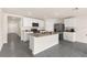 Modern open-concept kitchen featuring granite countertops, stainless steel appliances, and white cabinets at 7552 Gardner St, Brooksville, FL 34613
