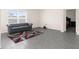 Bright living room featuring tile flooring, a cozy gray couch, and a modern patterned rug at 7552 Gardner St, Brooksville, FL 34613