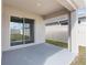 Covered patio with sliding glass door overlooking the backyard and white vinyl fence at 7552 Gardner St, Brooksville, FL 34613