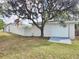 Backyard of property with detached garage and privacy wall at 8055 River Country Dr, Weeki Wachee, FL 34607