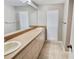 Bathroom featuring double sinks, large mirror and natural light at 8055 River Country Dr, Weeki Wachee, FL 34607