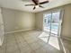 Bedroom with ceiling fan and sliding glass doors leading to screened pool area at 8055 River Country Dr, Weeki Wachee, FL 34607