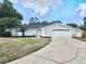 Charming single-story home features a well-manicured lawn and an attached two-car garage at 8055 River Country Dr, Weeki Wachee, FL 34607