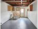 Spacious garage with ample storage, exposed ceiling, workbench and gray floor, perfect for projects or parking at 8055 River Country Dr, Weeki Wachee, FL 34607