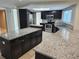Spacious kitchen with granite countertops, stainless steel appliances, and dark wood cabinetry at 8055 River Country Dr, Weeki Wachee, FL 34607