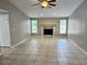 Large living room with a fireplace, neutral paint and tile floors at 8055 River Country Dr, Weeki Wachee, FL 34607