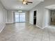 Open-concept living area with tile flooring and sliding glass doors to the pool area at 8055 River Country Dr, Weeki Wachee, FL 34607