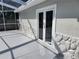 Covered patio with double doors leading inside at 8055 River Country Dr, Weeki Wachee, FL 34607