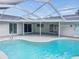 Screened in pool with view of house and covered patio at 8055 River Country Dr, Weeki Wachee, FL 34607