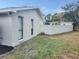 Side exterior with a privacy wall and green space at 8055 River Country Dr, Weeki Wachee, FL 34607