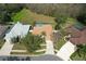 A high-angle shot of the home highlighting the spacious lawn and a private screened-in pool area at 8545 Orsi Ct, Trinity, FL 34655