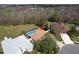 An aerial view showcasing the home with a pool, privacy fence, and proximity to a lush green space at 8545 Orsi Ct, Trinity, FL 34655