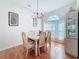 Cozy dining room featuring hardwood floors, a modern chandelier, and a large window at 8545 Orsi Ct, Trinity, FL 34655