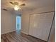 Bedroom featuring neutral walls, and wood-look floors, as well as a wardrobe style closet at 3233 Teeside Dr, New Port Richey, FL 34655