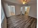 Bedroom featuring neutral walls, and wood-look floors, as well as doors to the Lanai at 3233 Teeside Dr, New Port Richey, FL 34655