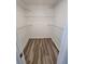 Walk-in closet is outfitted with wire shelving providing ample storage space and wood-look flooring at 3233 Teeside Dr, New Port Richey, FL 34655