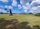 Scenic view of the golf course from the home featuring mature trees and blue skies at 3233 Teeside Dr, New Port Richey, FL 34655