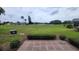 A tranquil view from the home's back patio overlooking the lush green golf course at 3233 Teeside Dr, New Port Richey, FL 34655