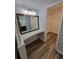 A well-lit hallway niche with a built-in vanity and a glimpse into a wired walk-in closet at 3233 Teeside Dr, New Port Richey, FL 34655