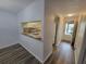 Open-concept living room leading to the kitchen with light-filled spaces at 3233 Teeside Dr, New Port Richey, FL 34655