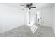 Bedroom with tile flooring, a ceiling fan and a view to the closet and bathroom at 3920 Edgemont Dr, New Port Richey, FL 34652